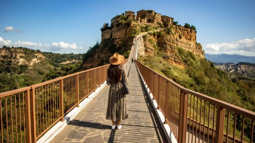 Rear view of a young woman standing on a bridge, Civita di Bagnoregio