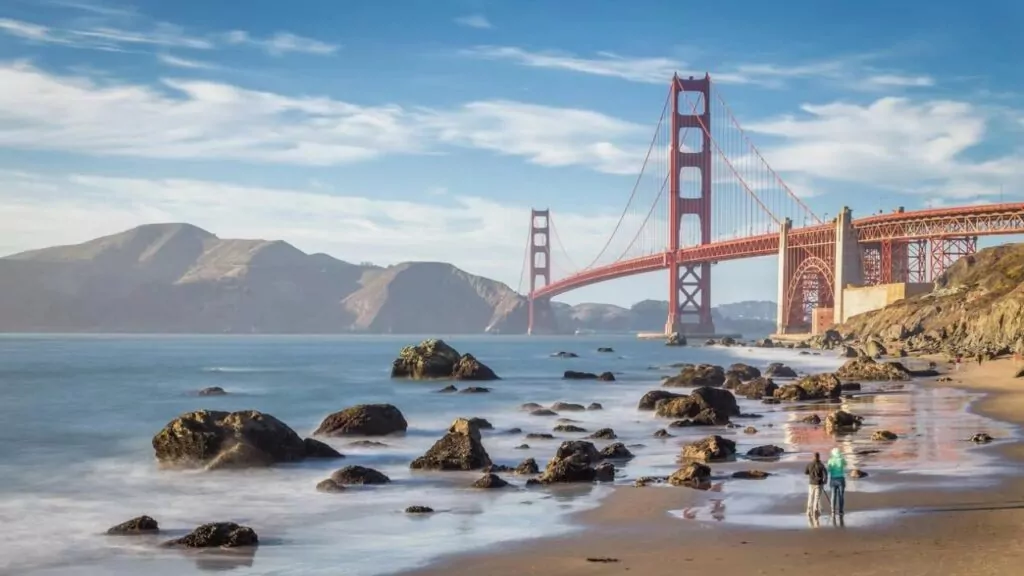 World famous Golden Gate Bridge at sunset seen from Baker Beach, San Francisco, California, USA