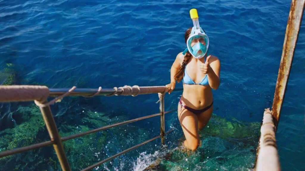 Young woman in full face snorkeling mask