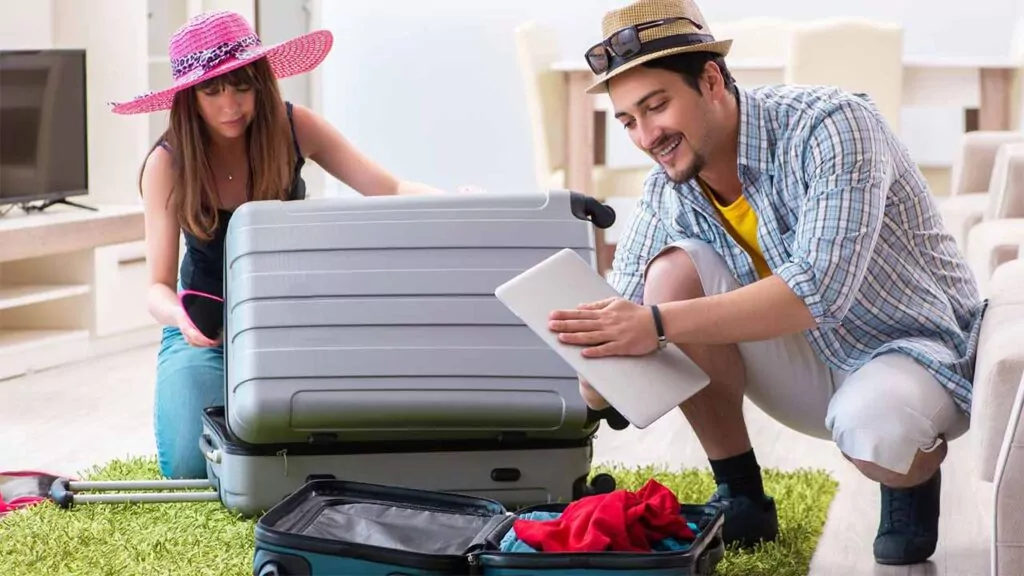 Couple packing suitcases for vacation, ready for a trip.